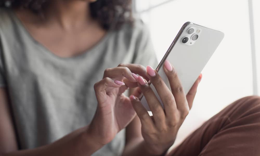 woman typing on iPhone